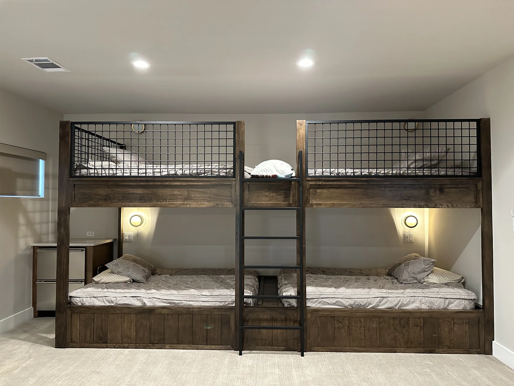 Custom wood and metal bunk beds with individual reading lights