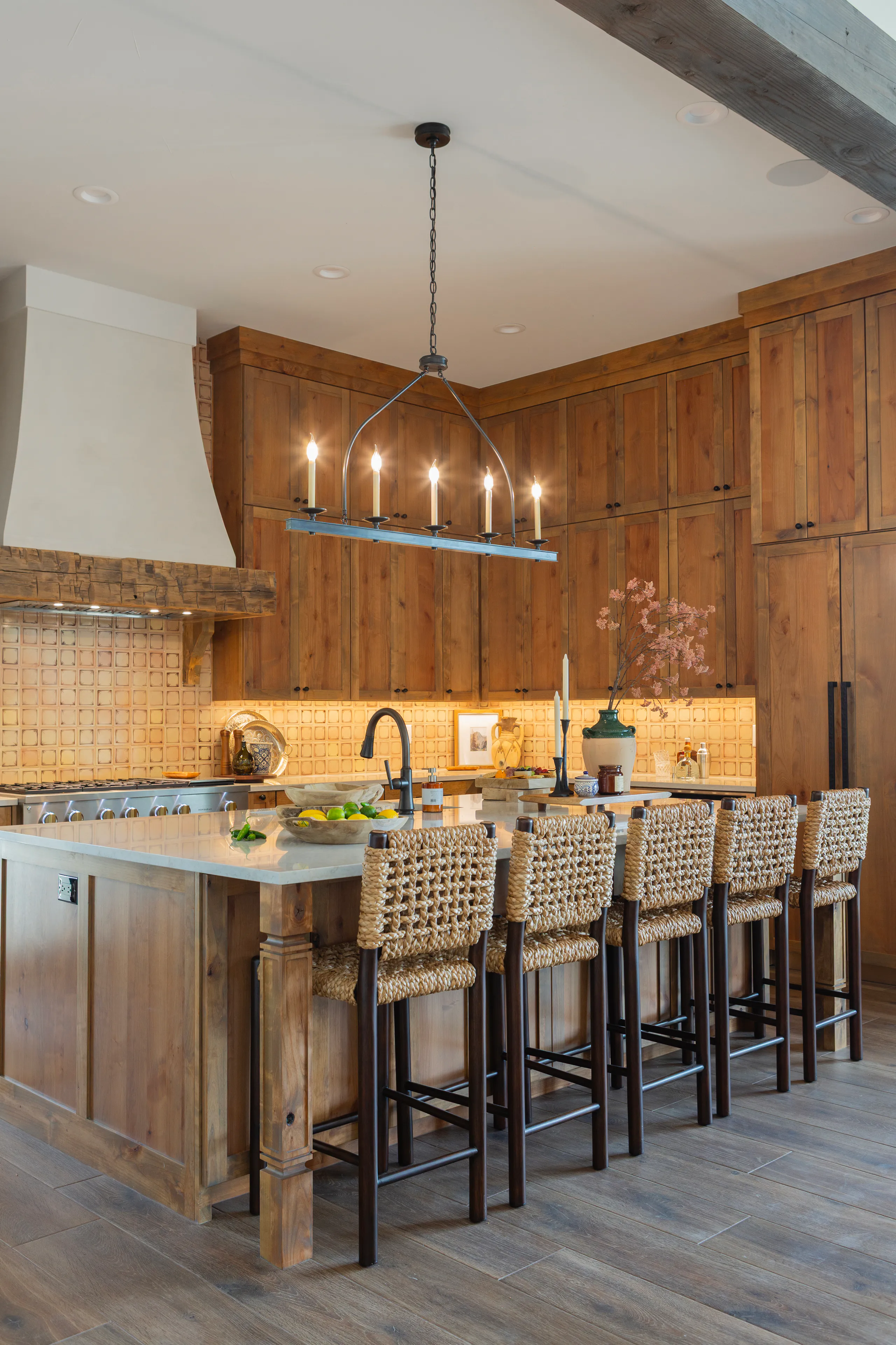 Chef’s kitchen with marble waterfall island and pendant lighting