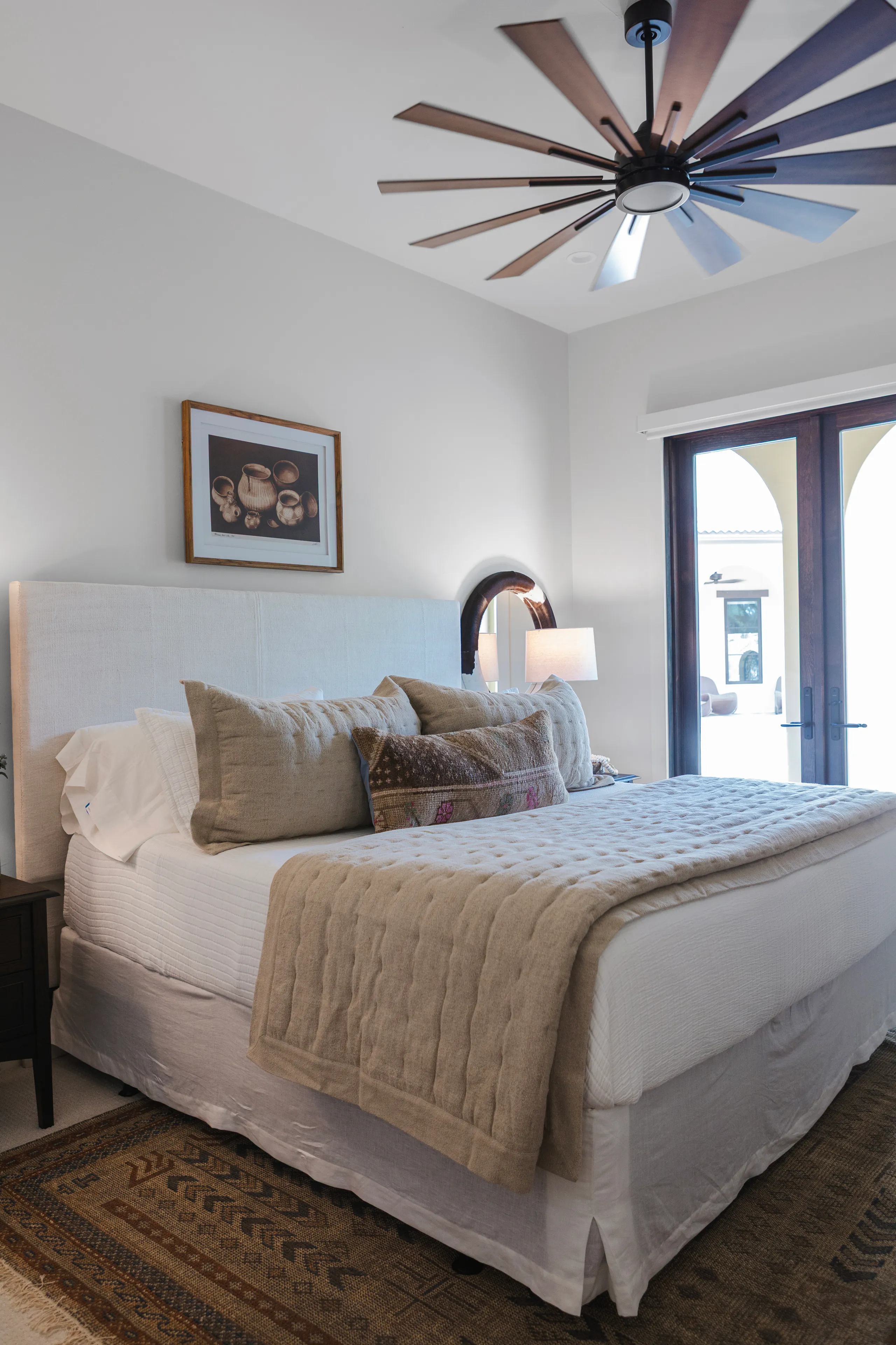 Guest bedroom with custom headboard and art