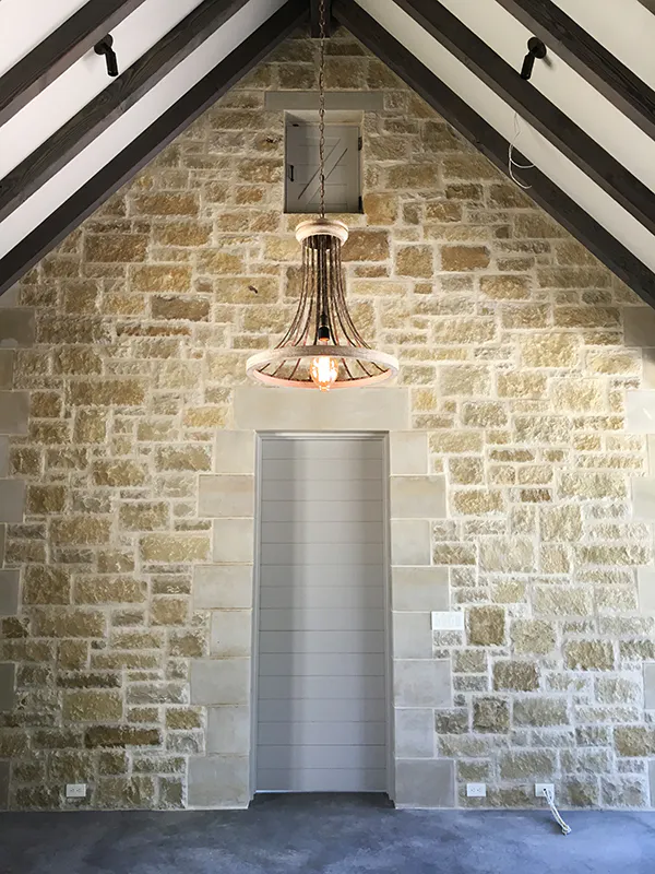 Kevin-Travis-Homes_Rustic-cabin-stone-with-rafters.jpg