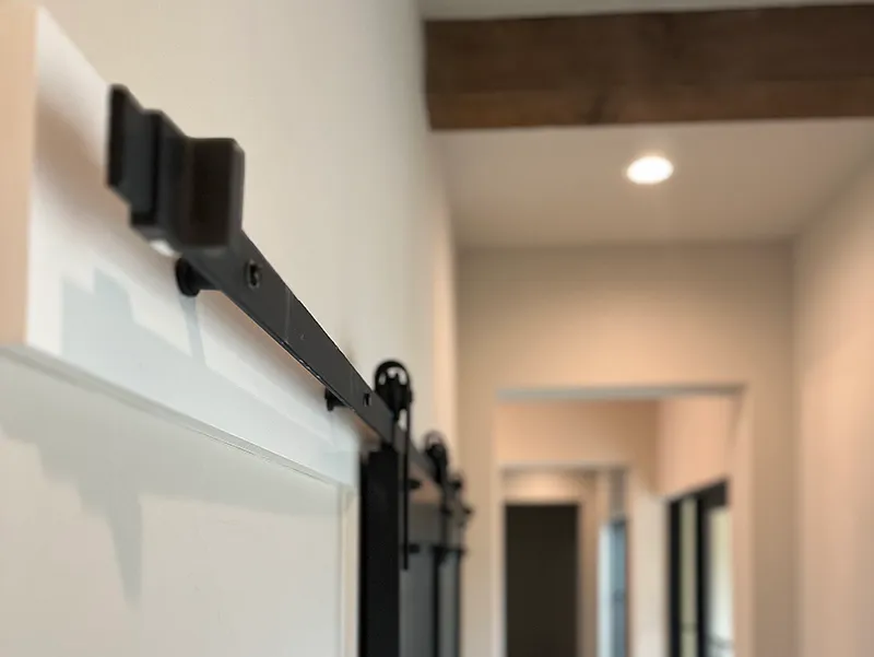 Kevin-Travis-Homes_Barn-door-with-wooden-beams.jpg