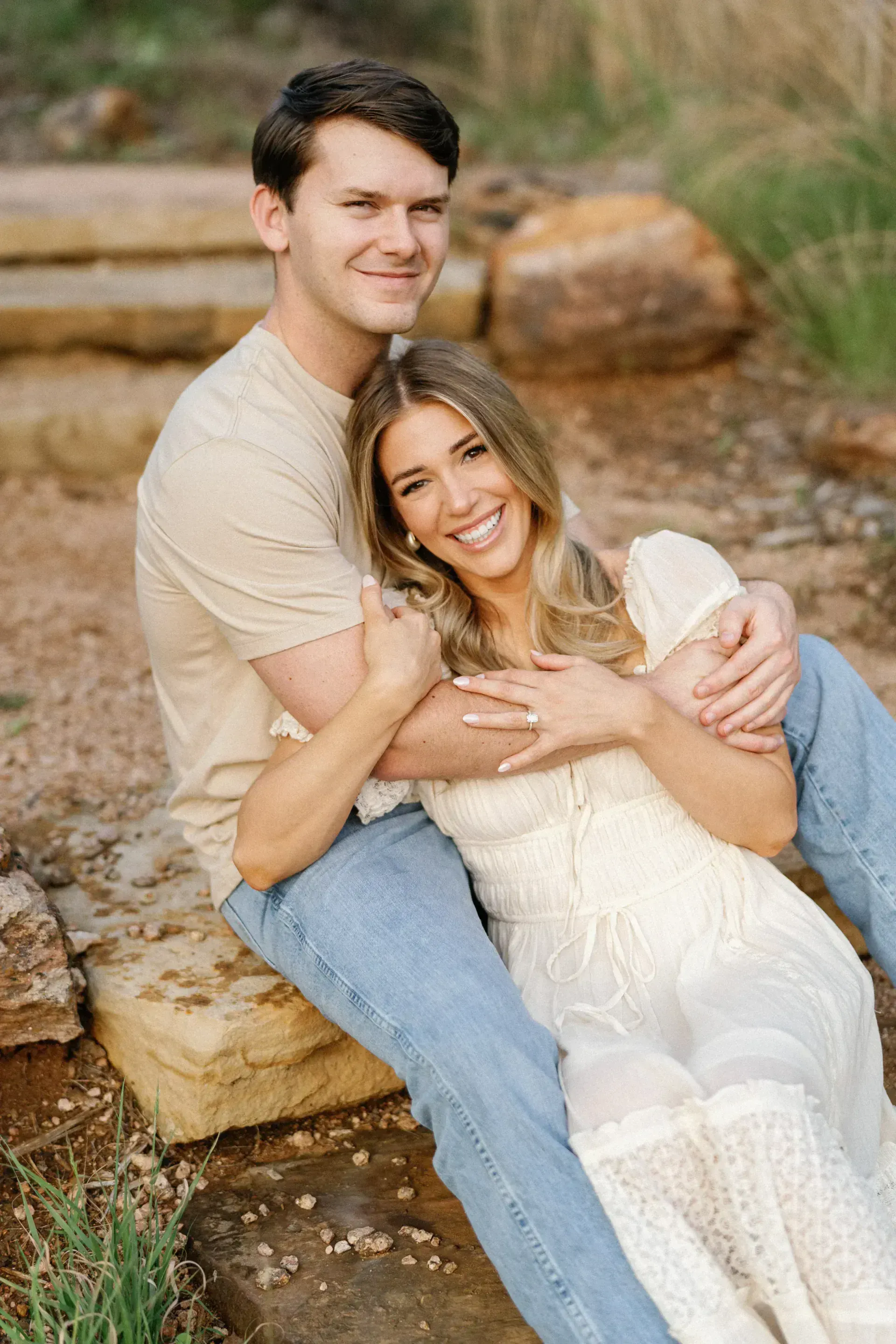 Couple sitting together during styled engagement session in Texas Hill Country