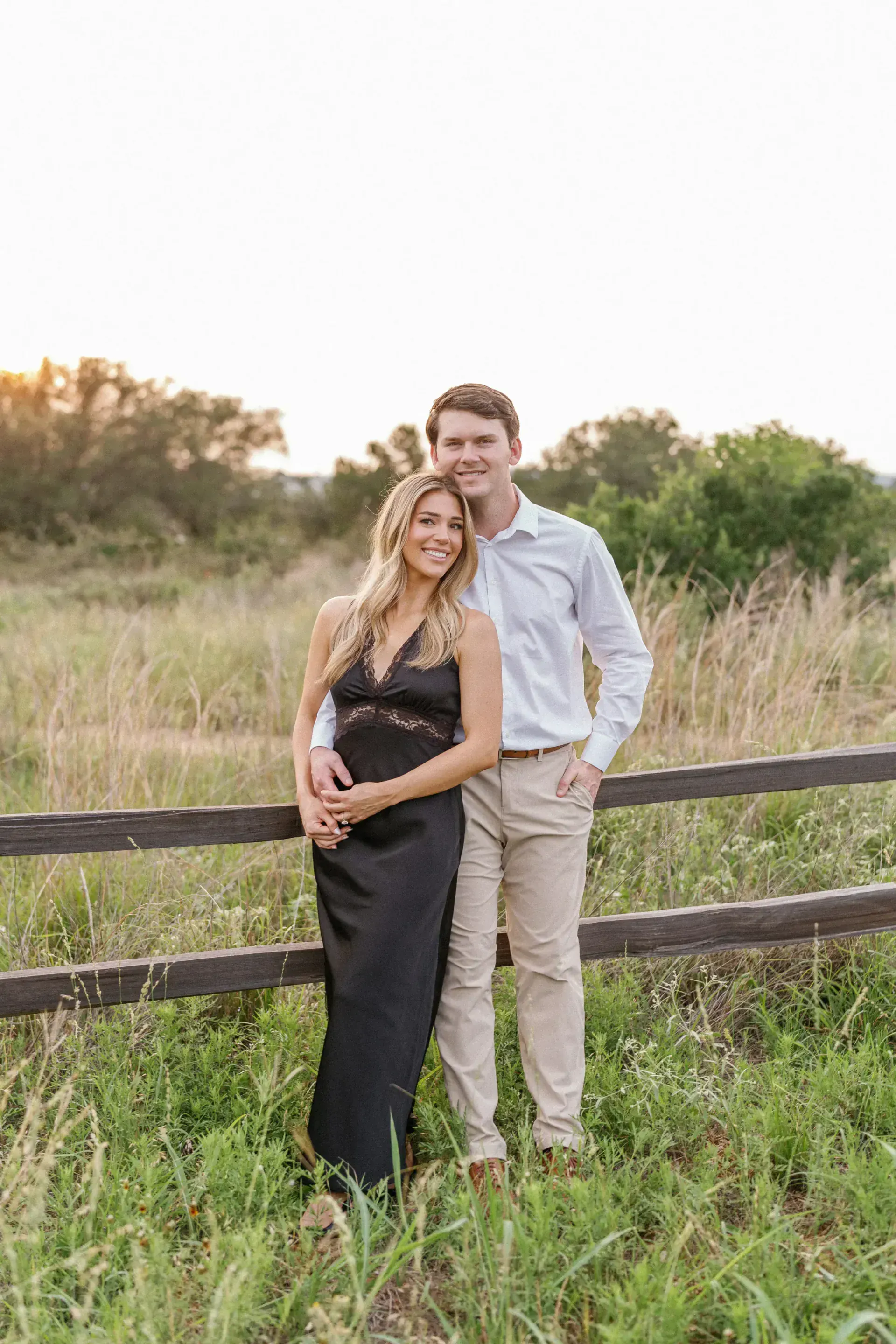 Couple embracing with scenic Texas Hill Country backdrop by Krystal Eve Weddings