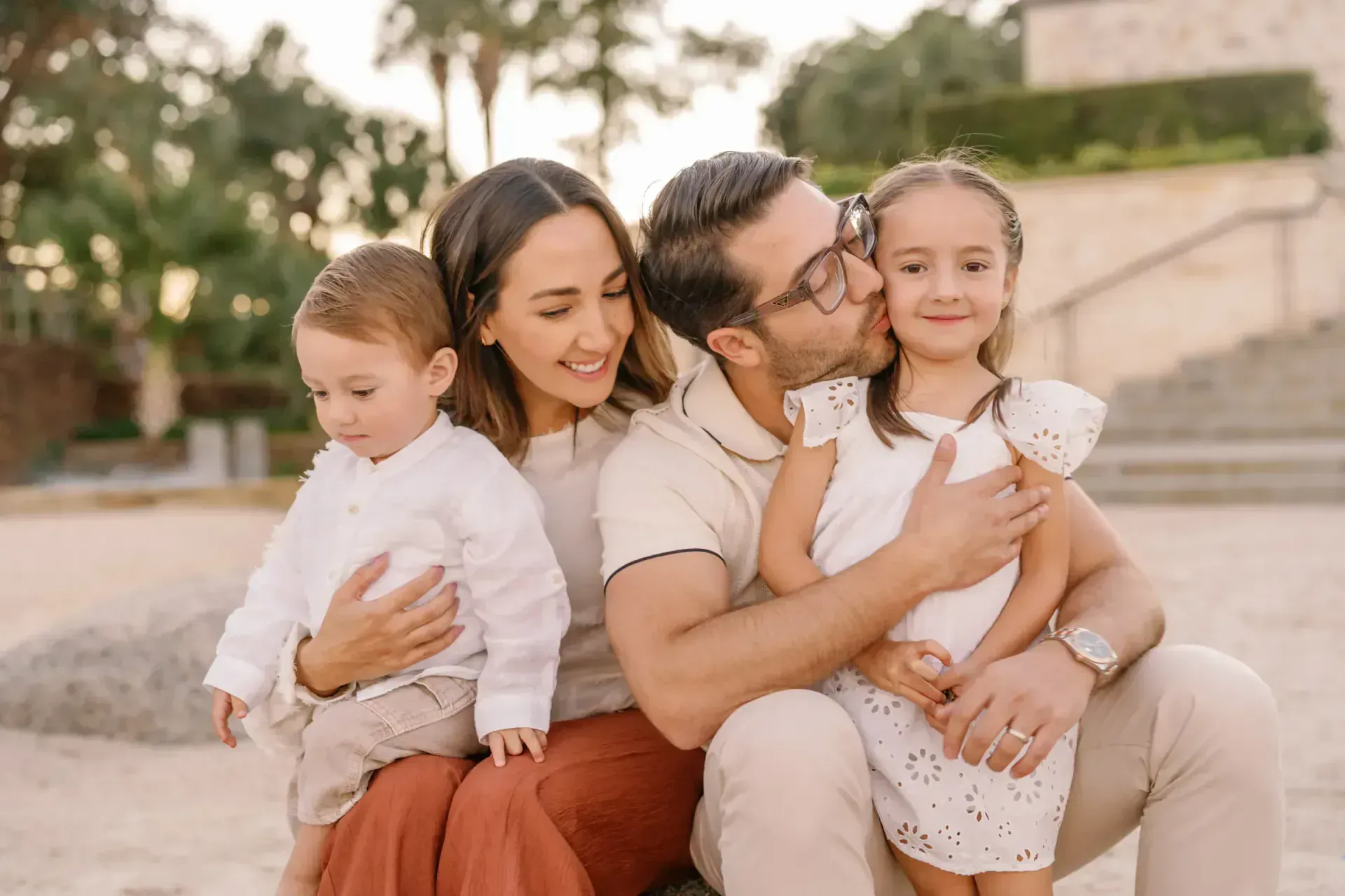 Family sitting together under a tree canopy in Texas Hill Country
