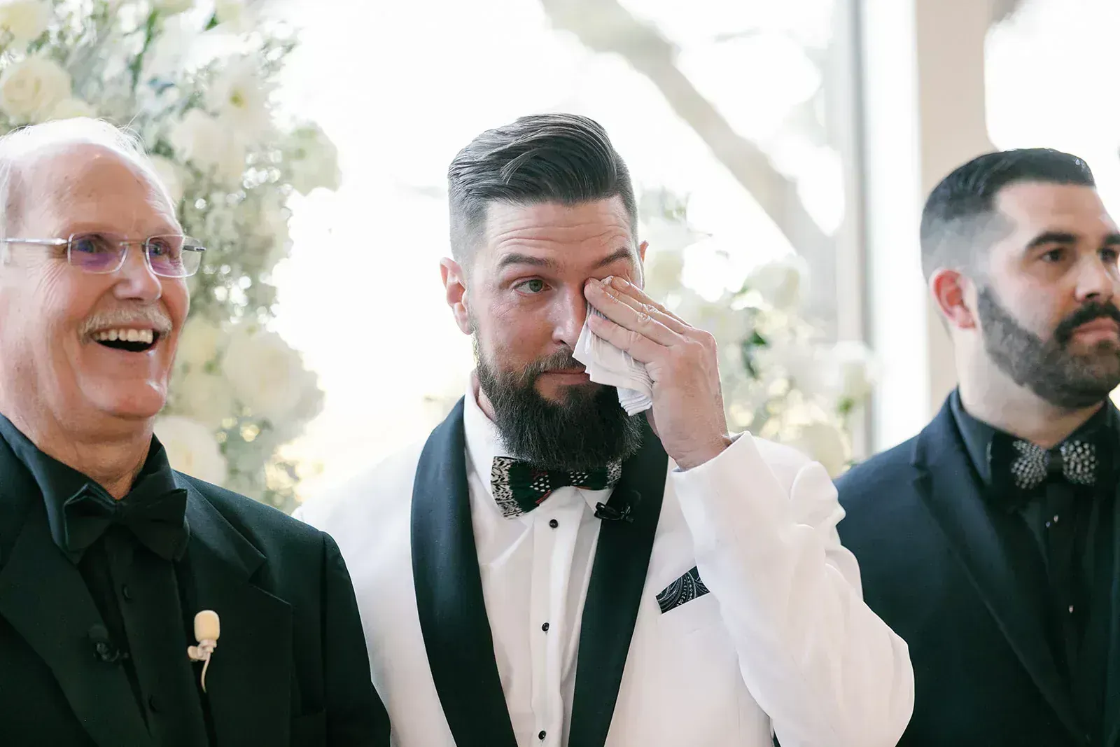 Emotional groom wiping tears at ceremony by Krystal Eve Weddings