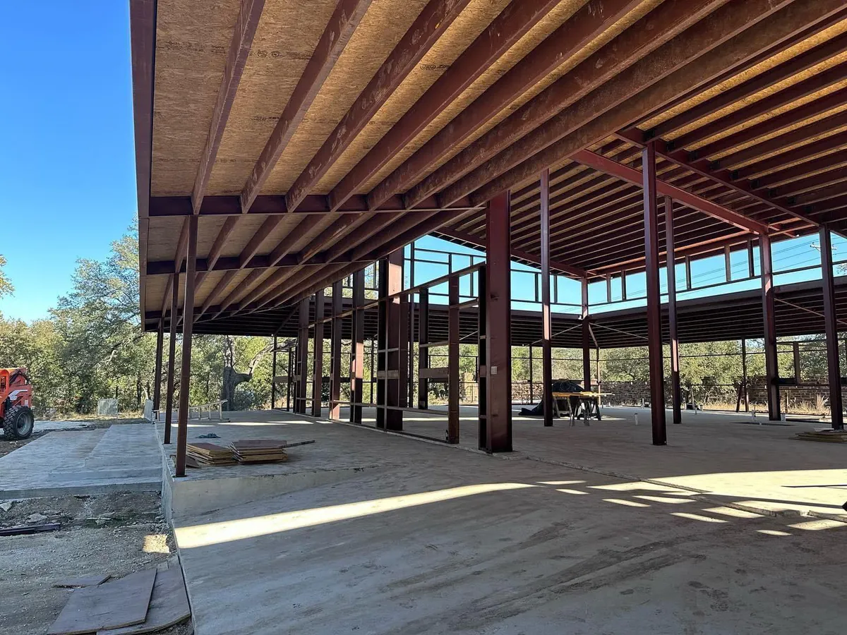 A large building under construction with a blue sky in the background
