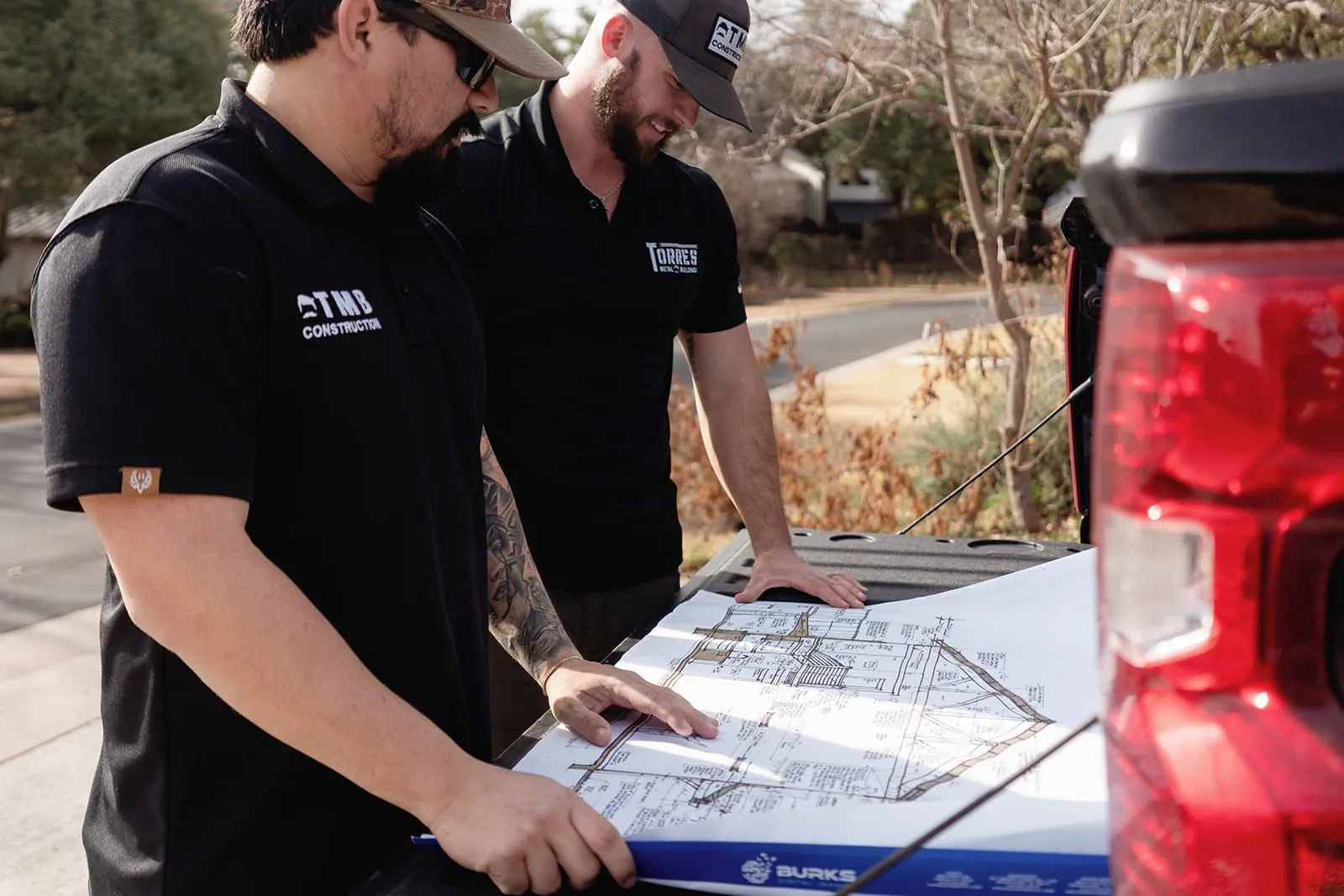 TMB Construction team reviewing blueprints