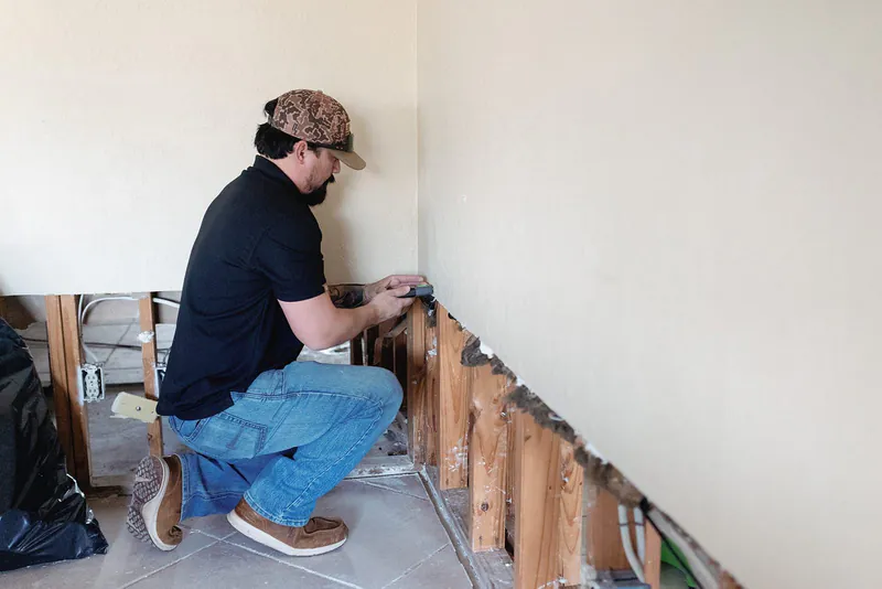 Justin Torres inspecting wall framing