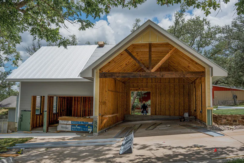 Barndominium timber truss entry under construction