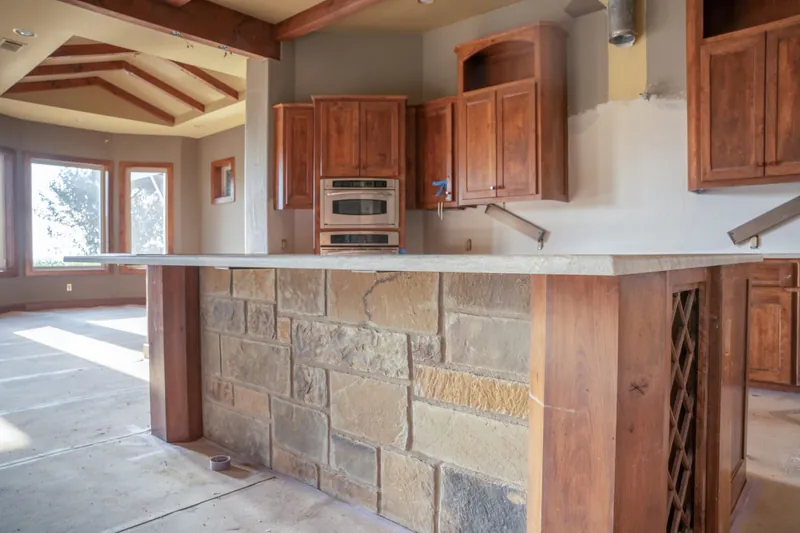 Custom kitchen with stone island and wood cabinets