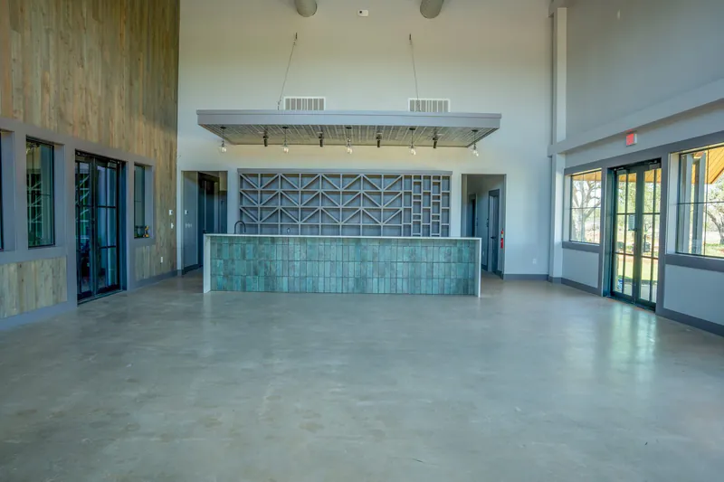 Event venue with tiled bar and polished concrete interior