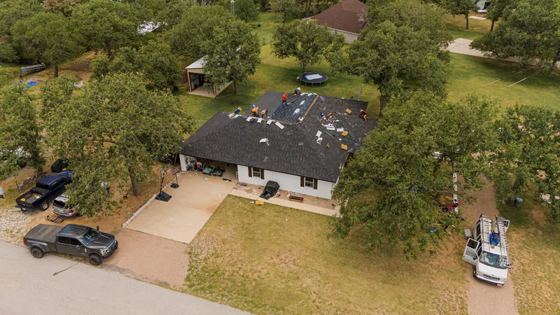 TMB Construction crew performing roof replacement aerial view