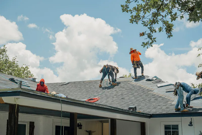 TMB roofing team installing shingles on residential home