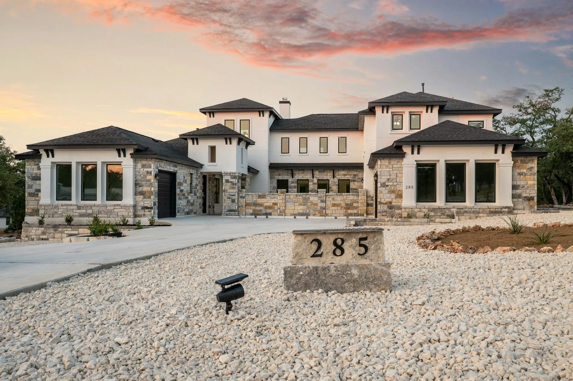 Modern Texas Hill Country home at dusk, Peak Storm Services performs full-property damage inspections